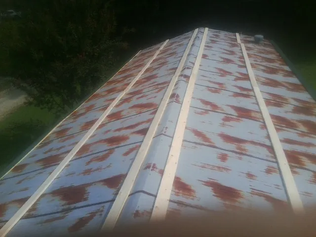 Rusted metal roof panels with new wood purlins before replacement — Storm Damage Roof Repair in Alcoa by Roofing Brothers