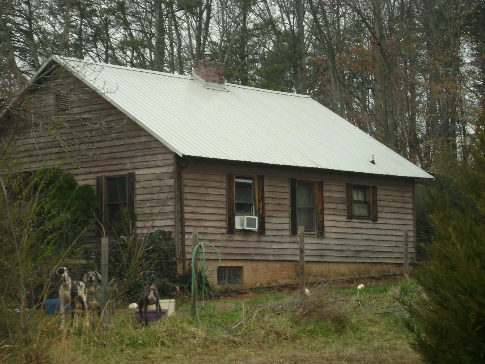 White metal roof on an old wood sided farmhouse, from a Metal Roof Installation job in Alcoa
